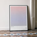 A framed Get Out movie script poster leaning against a wall in a minimalist interior.