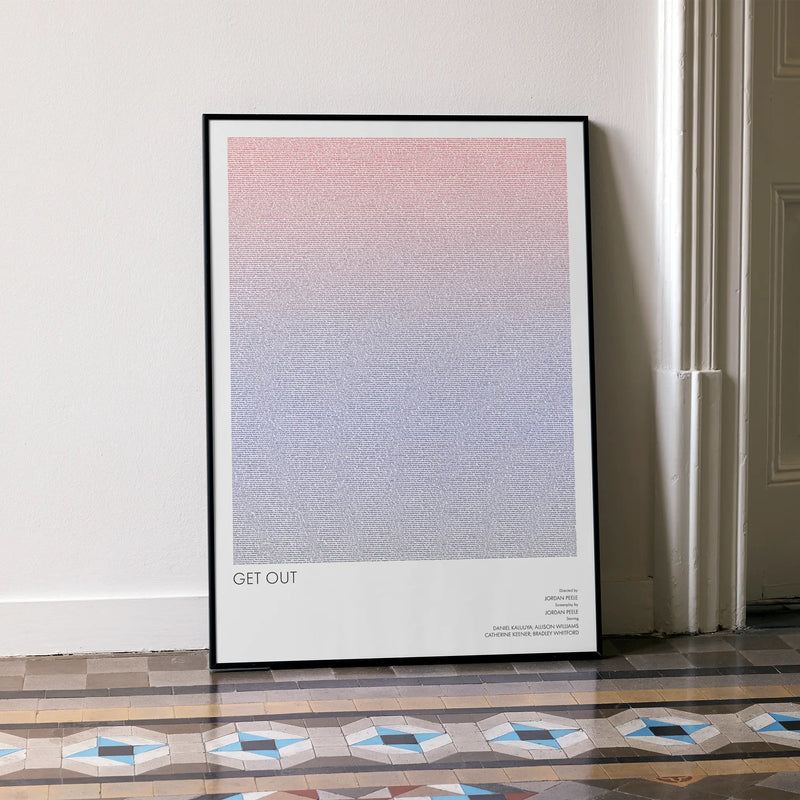 A framed Get Out movie script poster leaning against a wall in a minimalist interior.