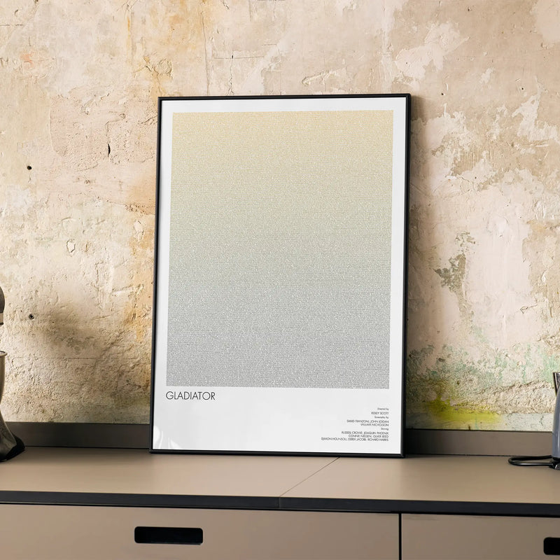 A framed Gladiator movie script poster displayed on a cabinet in a minimalist interior.