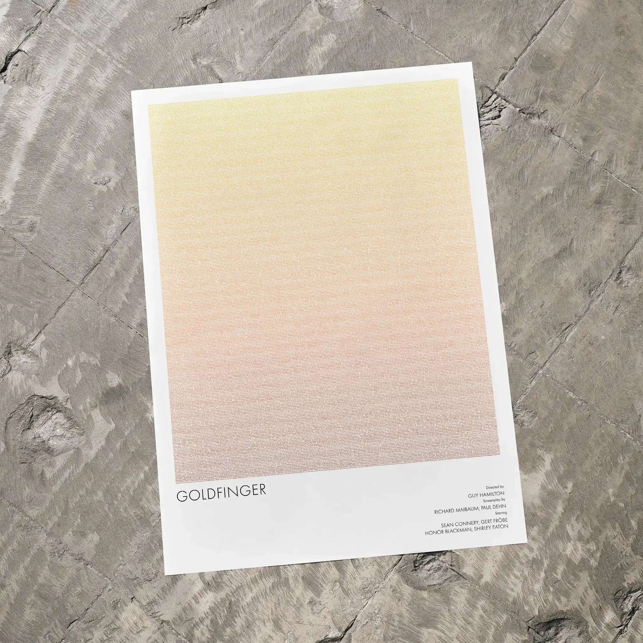 A Goldfinger movie script poster laid flat on a textured floor surface.