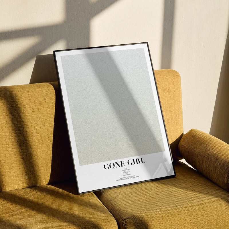 A framed Gone Girl movie script poster styled in a clean interior setting.