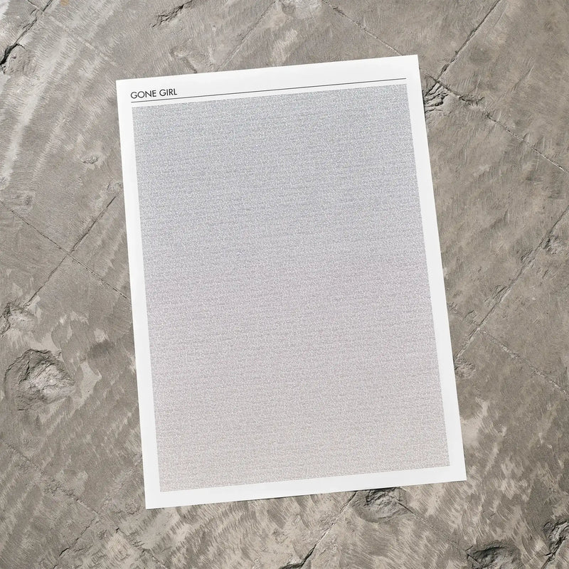 A Gone Girl movie script poster laid flat on a textured floor surface.