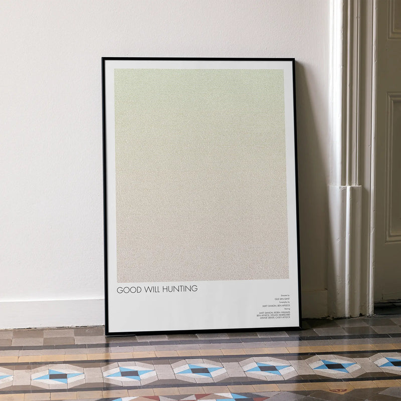 A framed Good Will Hunting movie script poster leaning against a wall in a minimalist interior.