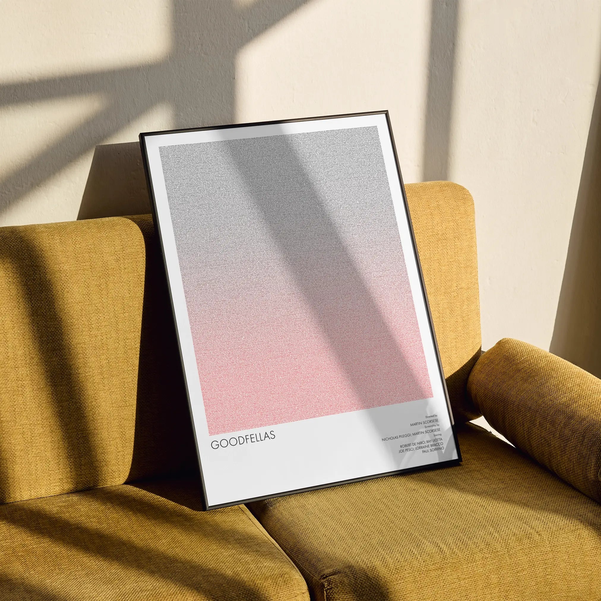A framed Goodfellas movie script poster styled in a clean interior setting.