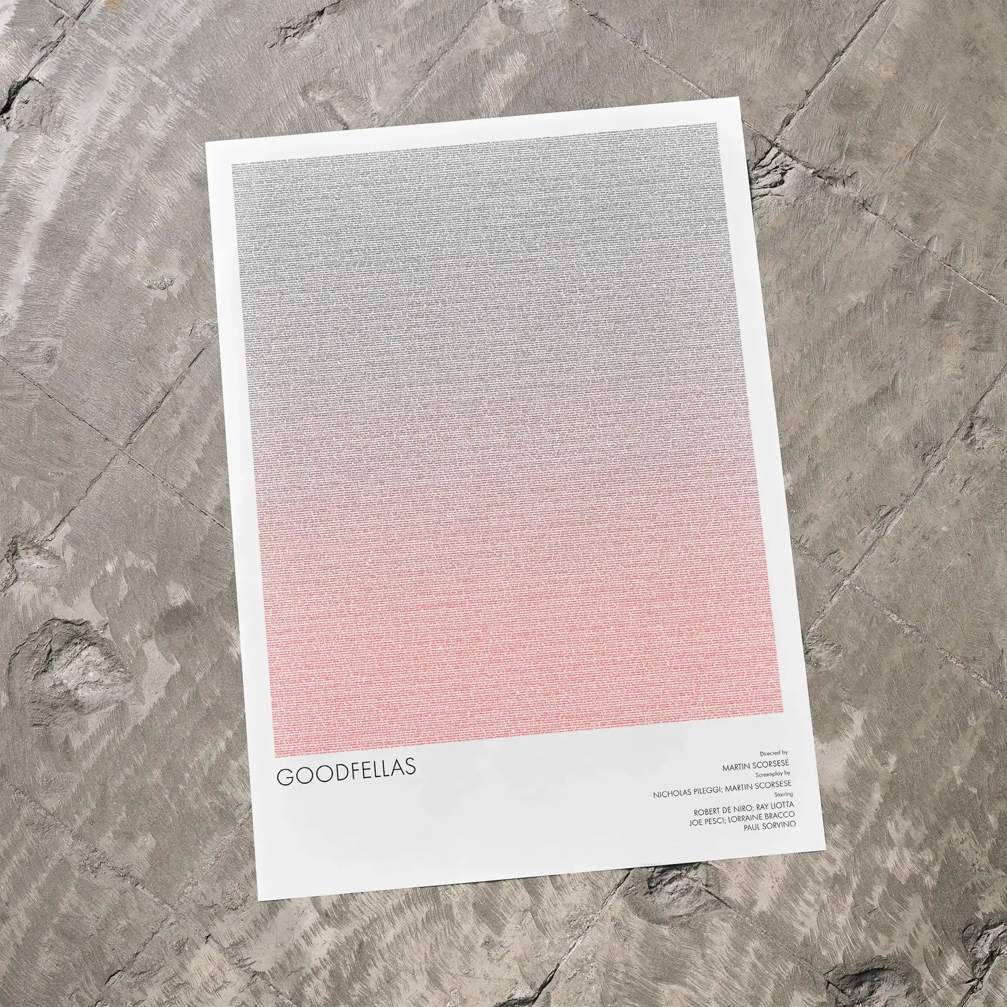 A Goodfellas movie script poster laid flat on a textured floor surface.