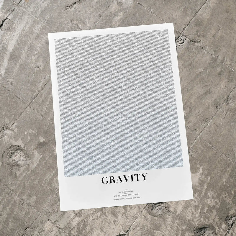 A Gravity movie script poster laid flat on a textured floor surface.