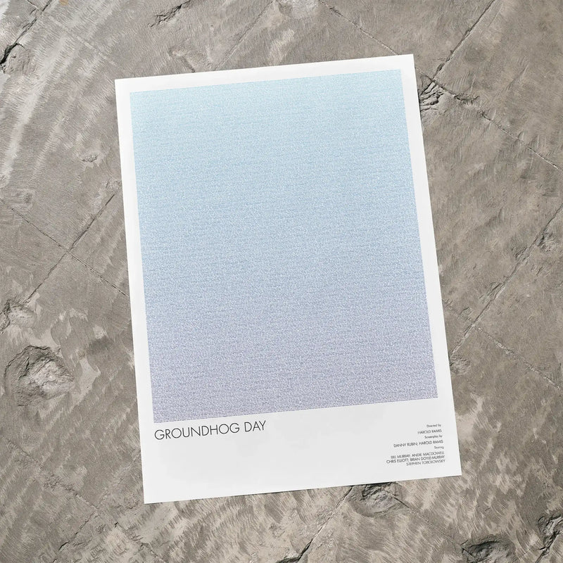 A Groundhog Day movie script poster laid flat on a textured floor surface.