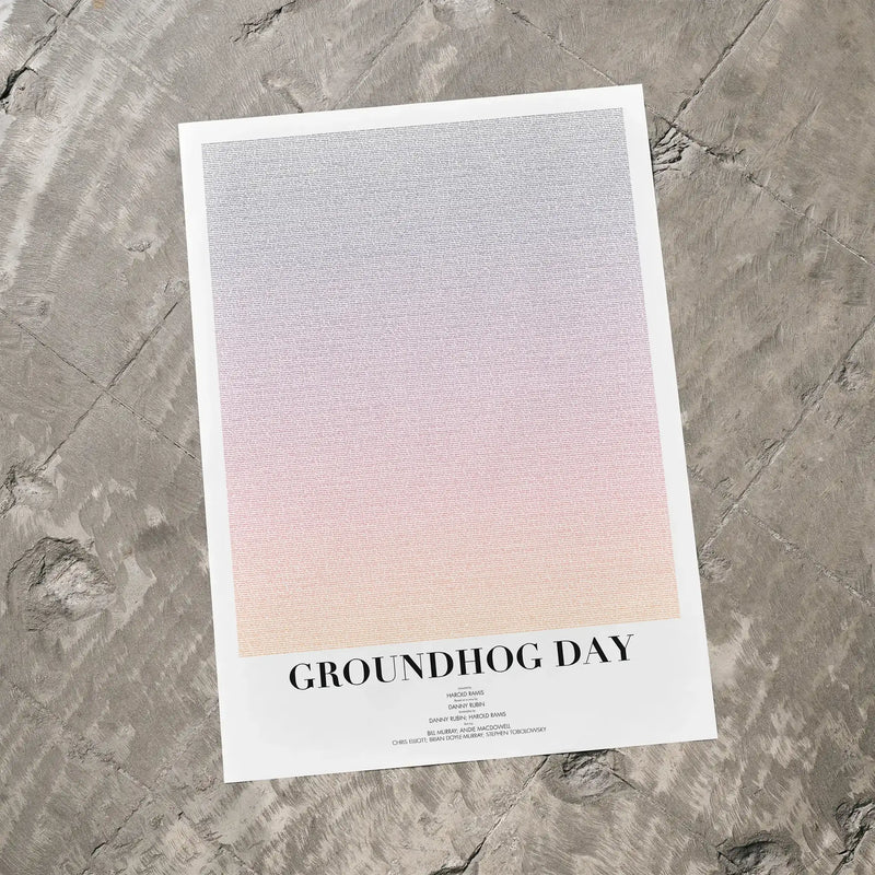 A Groundhog Day movie script poster laid flat on a textured floor surface.