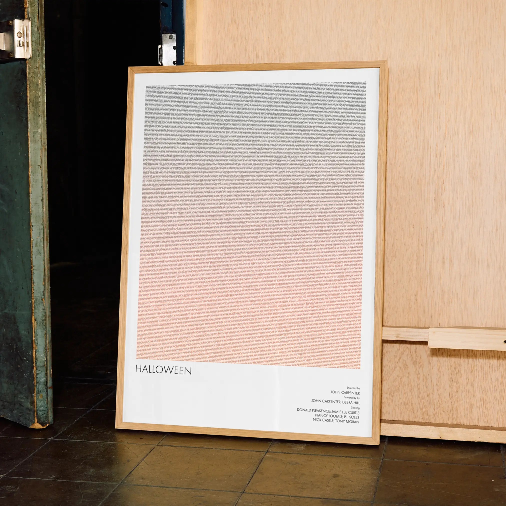 A framed Halloween movie script poster displayed in a contemporary interior setting.