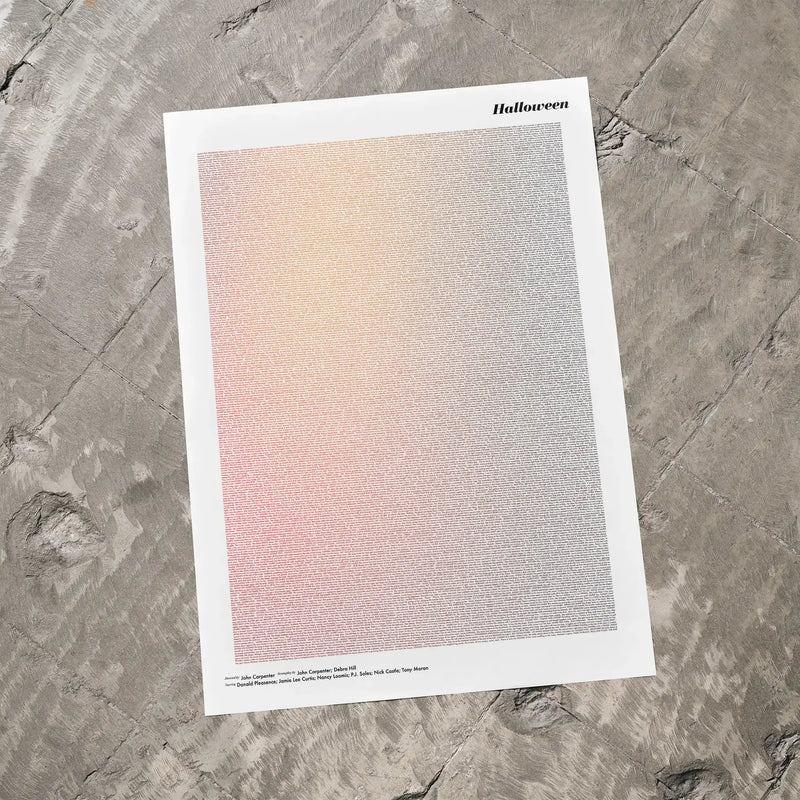 A Halloween movie script poster laid flat on a textured floor surface.