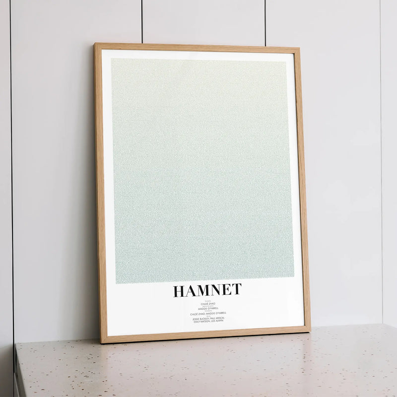 A framed Hamnet movie script poster styled within a calm interior space.