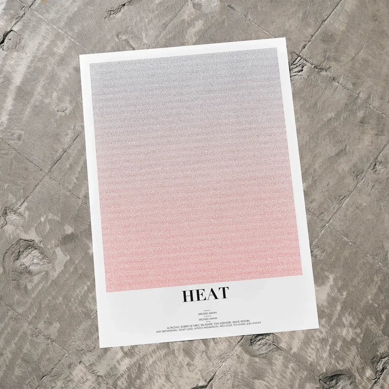 A Heat movie script poster laid flat on a textured floor surface.