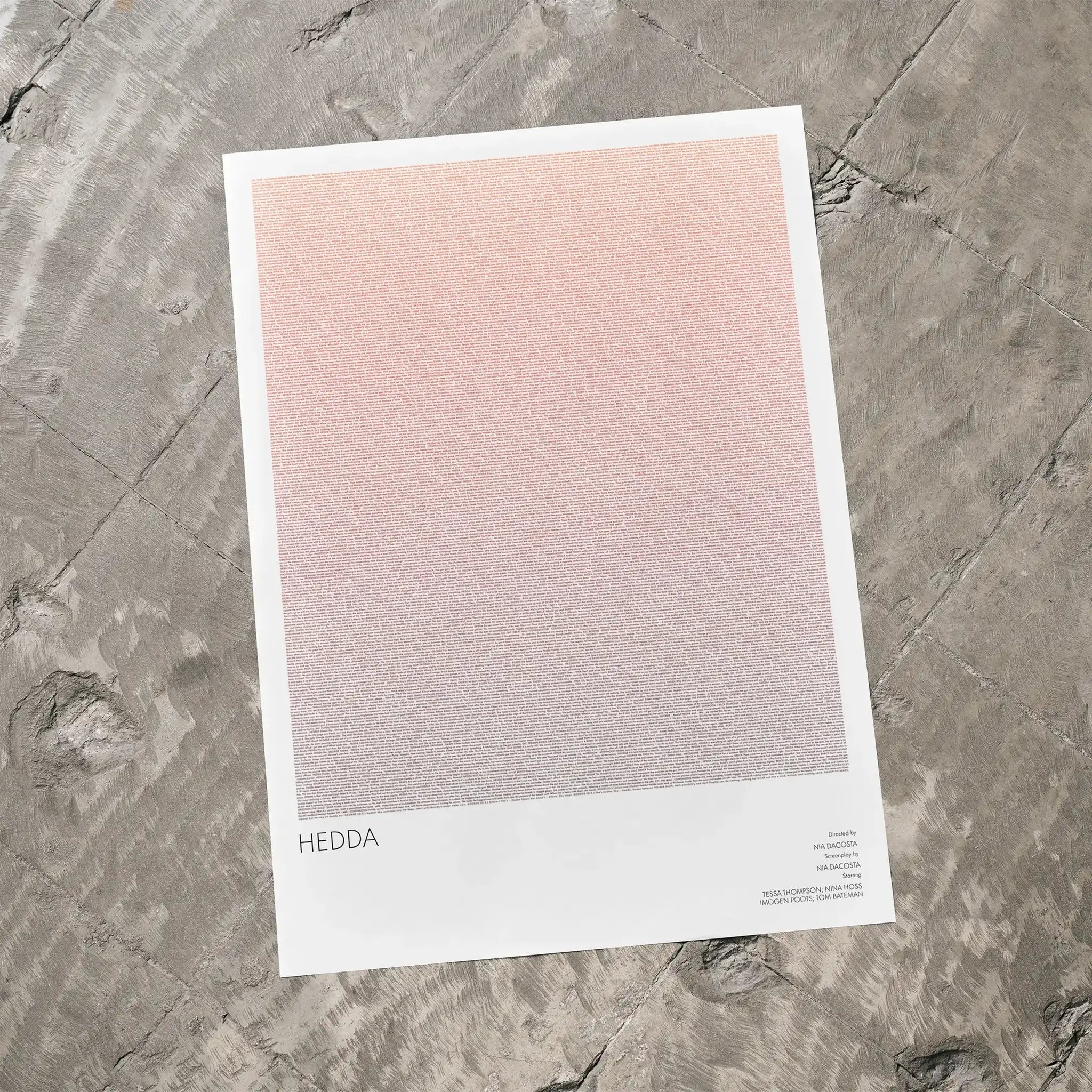 A Hedda movie script poster laid flat on a textured floor surface.