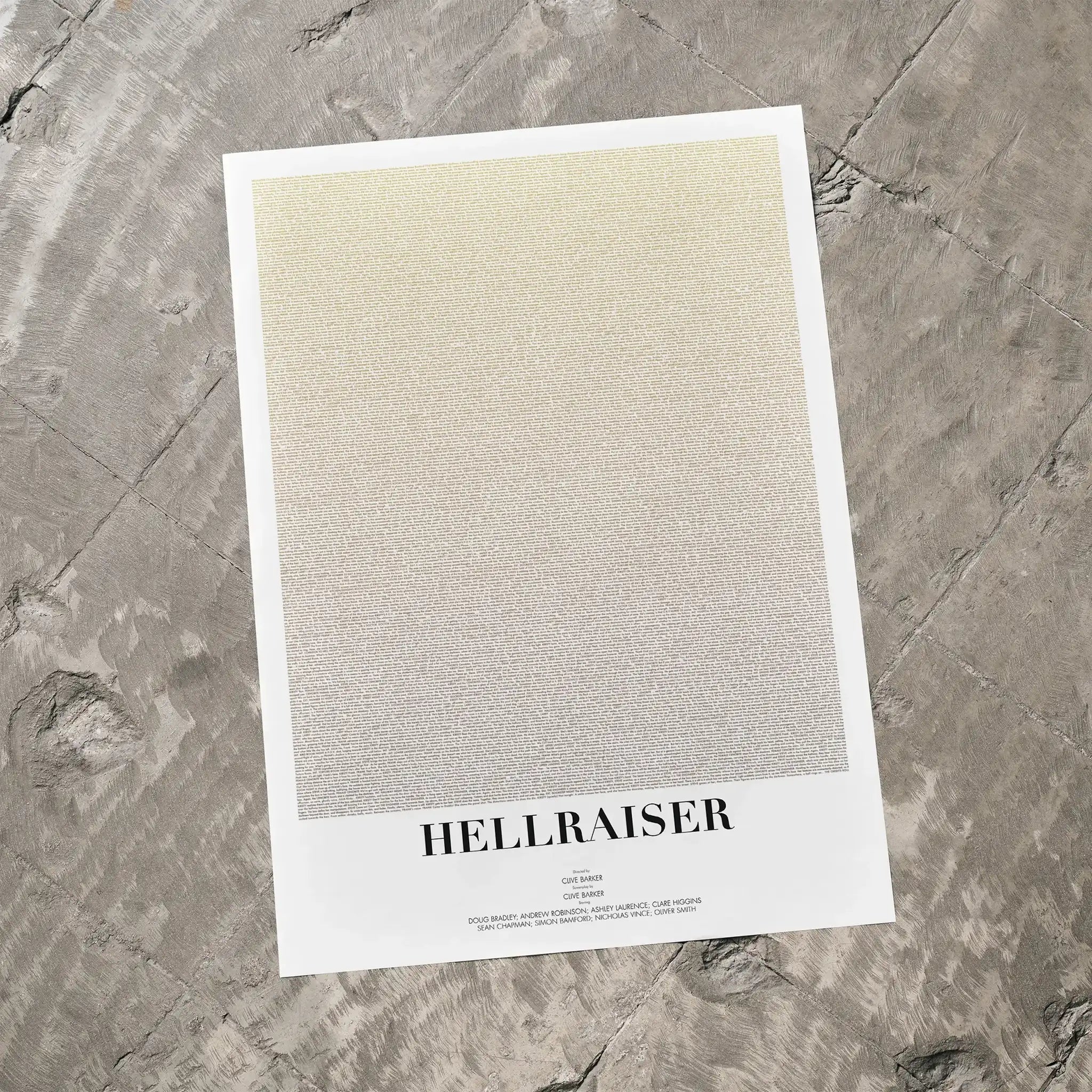 A Hellraiser movie script poster laid flat on a textured floor surface.