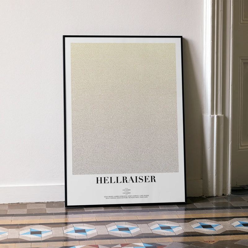 A framed Hellraiser movie script poster leaning against a wall in a minimalist interior.