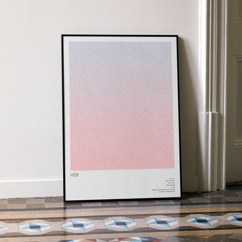 A framed Her movie script poster leaning against a wall in a minimalist interior.