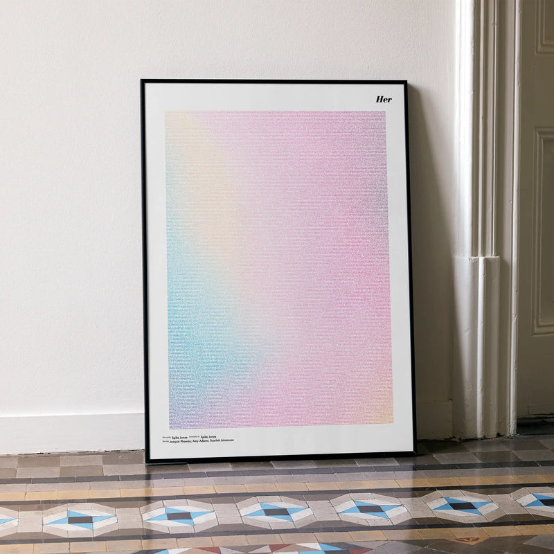 A framed Her movie script poster leaning against a wall in a minimalist interior.