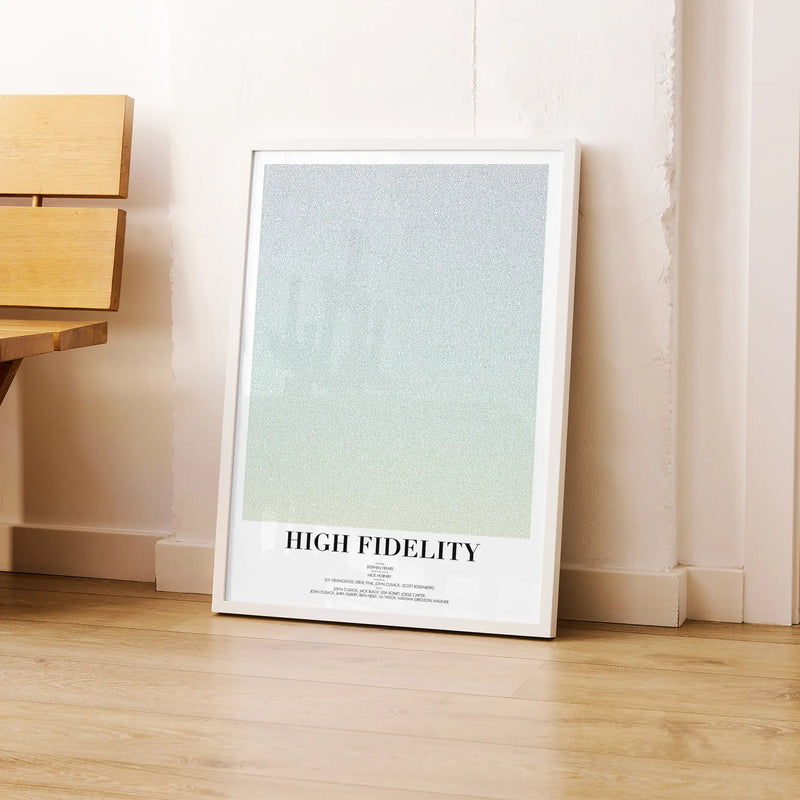 A framed High Fidelity movie script poster leaning against a wall in a modern interior.