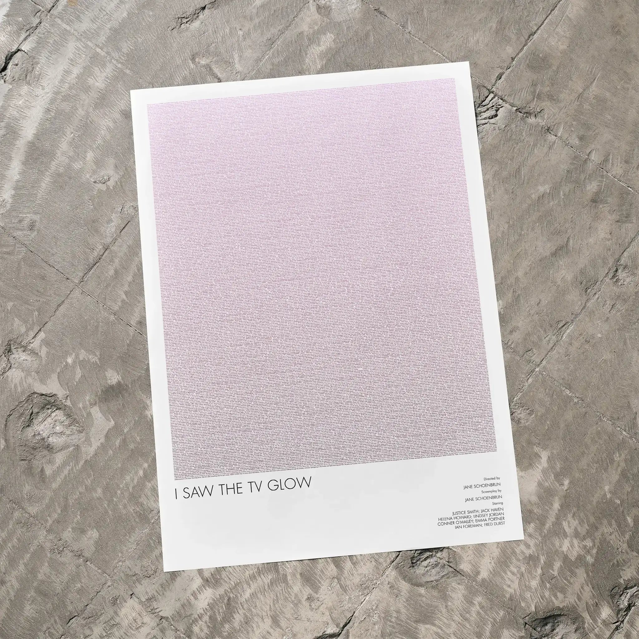 A I Saw the TV Glow movie script poster laid flat on a textured floor surface.