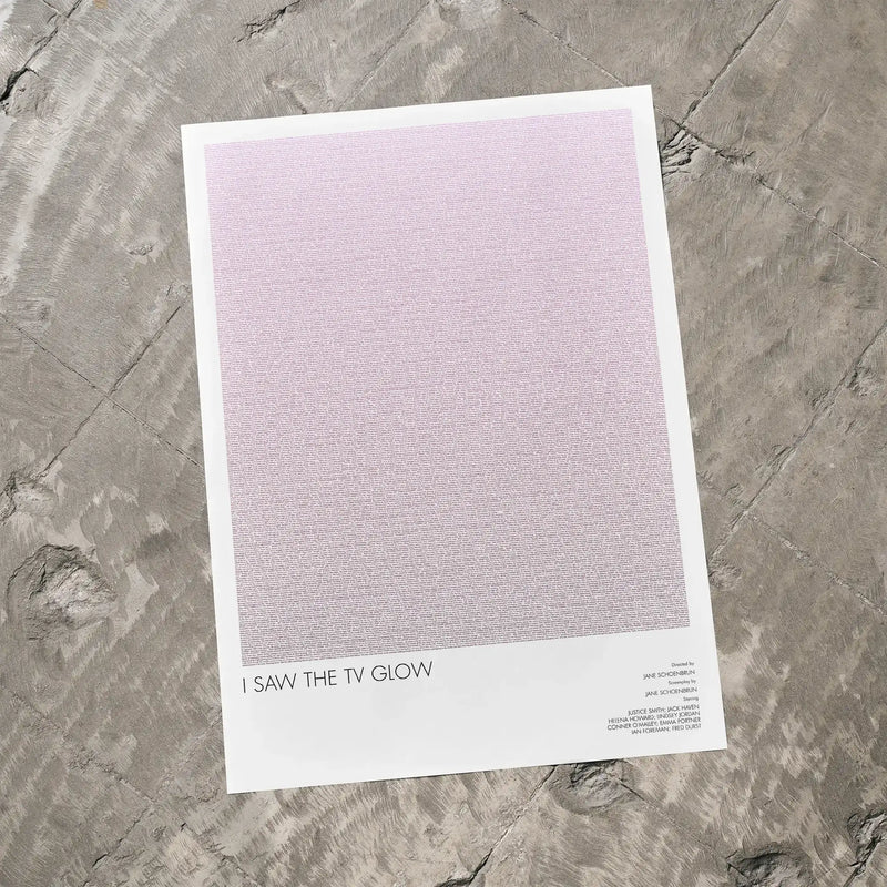 A I Saw the TV Glow movie script poster laid flat on a textured floor surface.