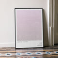 A framed I Saw the TV Glow movie script poster leaning against a wall in a minimalist interior.