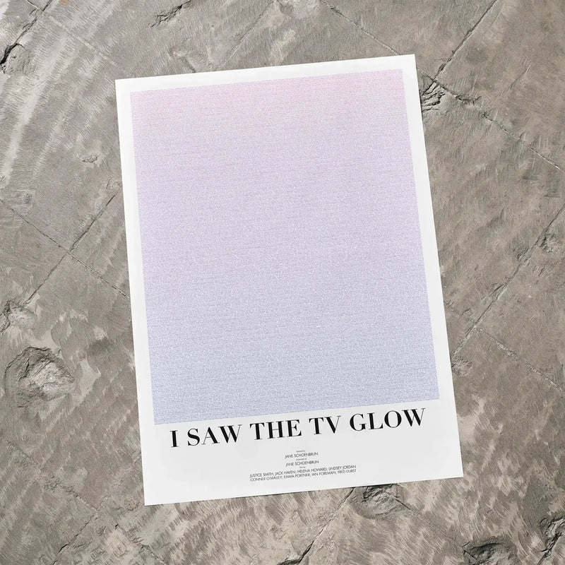 A I Saw the TV Glow movie script poster laid flat on a textured floor surface.