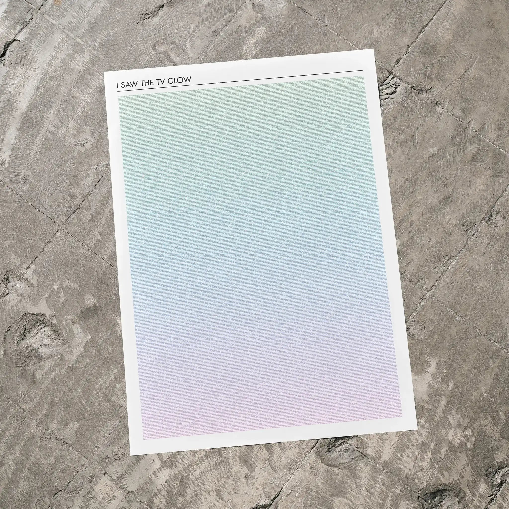 A I Saw the TV Glow movie script poster laid flat on a textured floor surface.