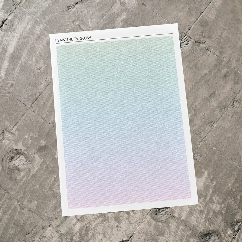 A I Saw the TV Glow movie script poster laid flat on a textured floor surface.