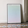 A framed I Saw the TV Glow movie script poster leaning against a wall in a minimalist interior.