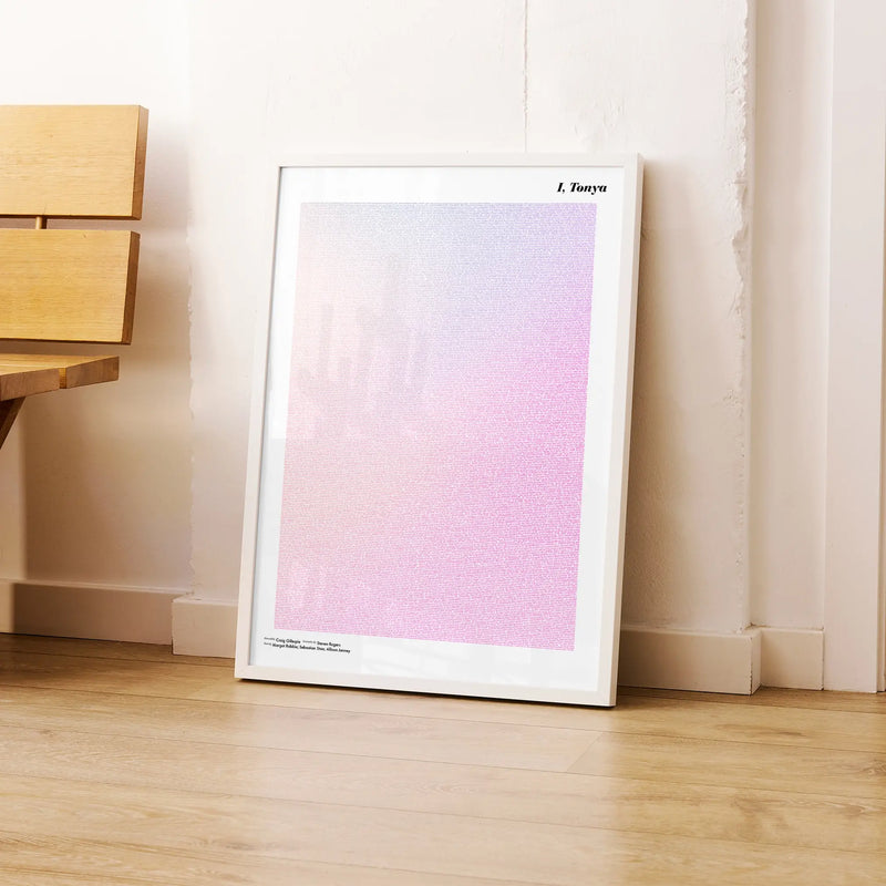 A framed I, Tonya movie script poster leaning against a wall in a modern interior.