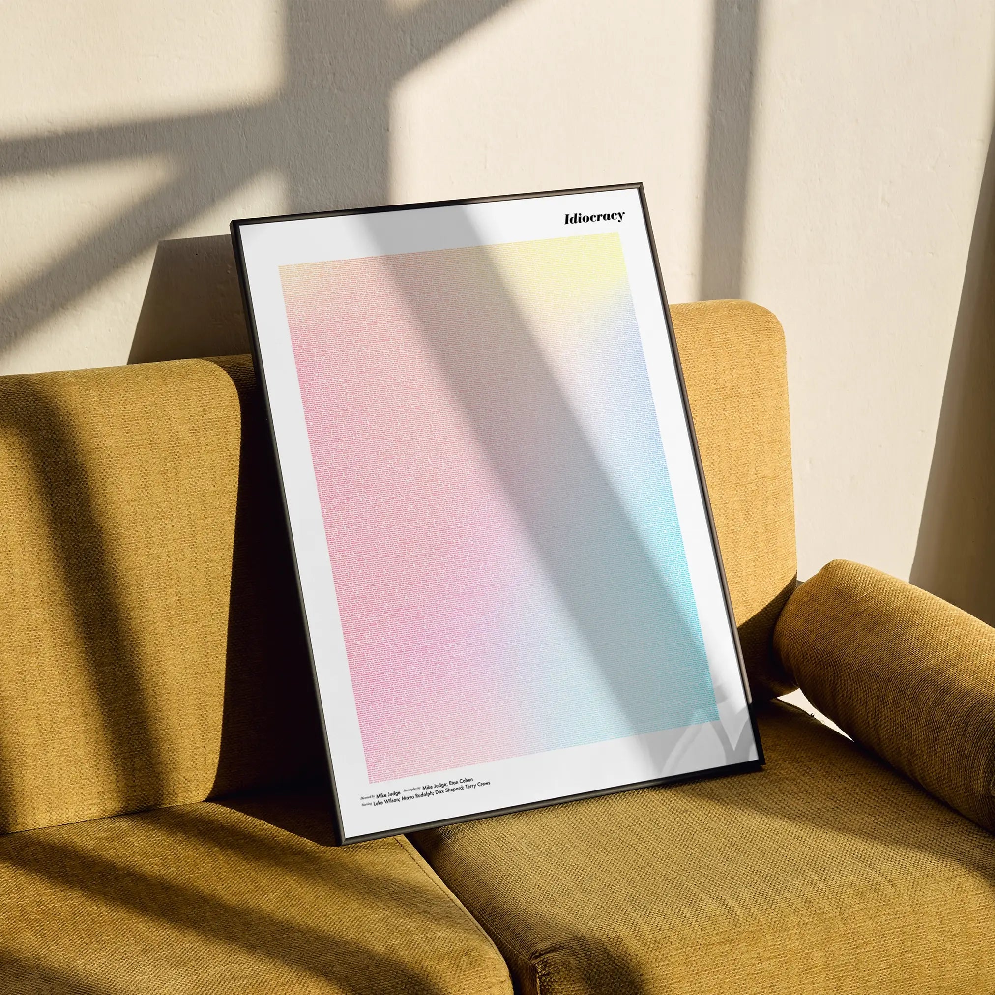 A framed Idiocracy movie script poster styled in a clean interior setting.