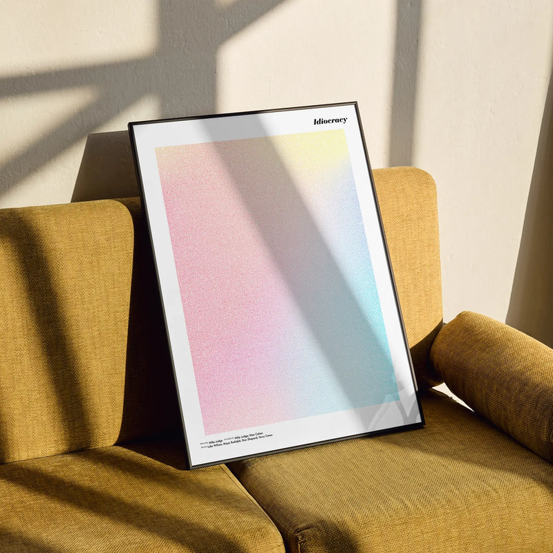 A framed Idiocracy movie script poster styled in a clean interior setting.