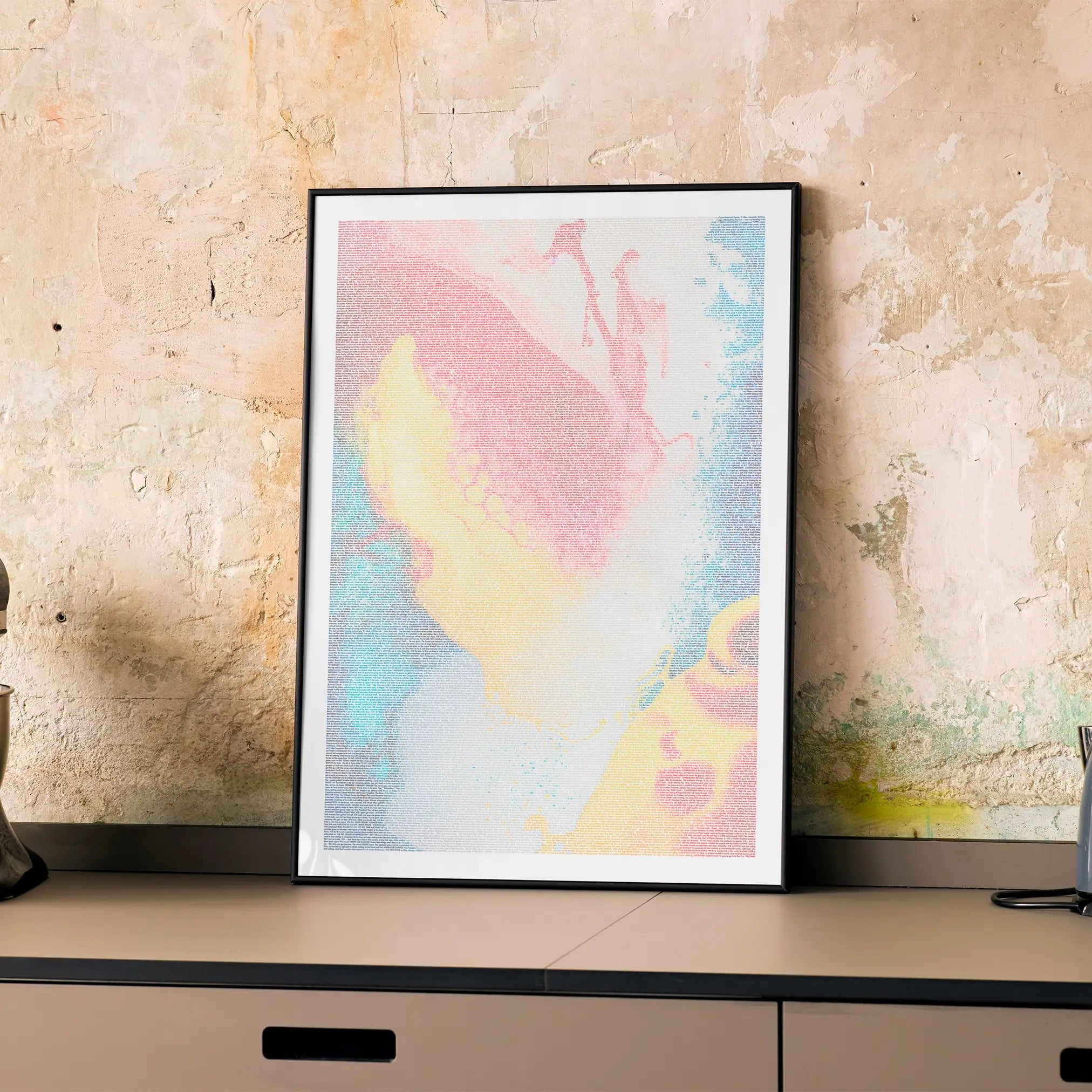 A framed Idiocracy movie script poster displayed on a cabinet in a minimalist interior.