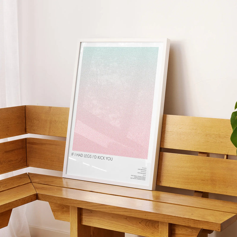 A framed If I Had Legs I'd Kick You movie script poster displayed on a sideboard in a contemporary space.