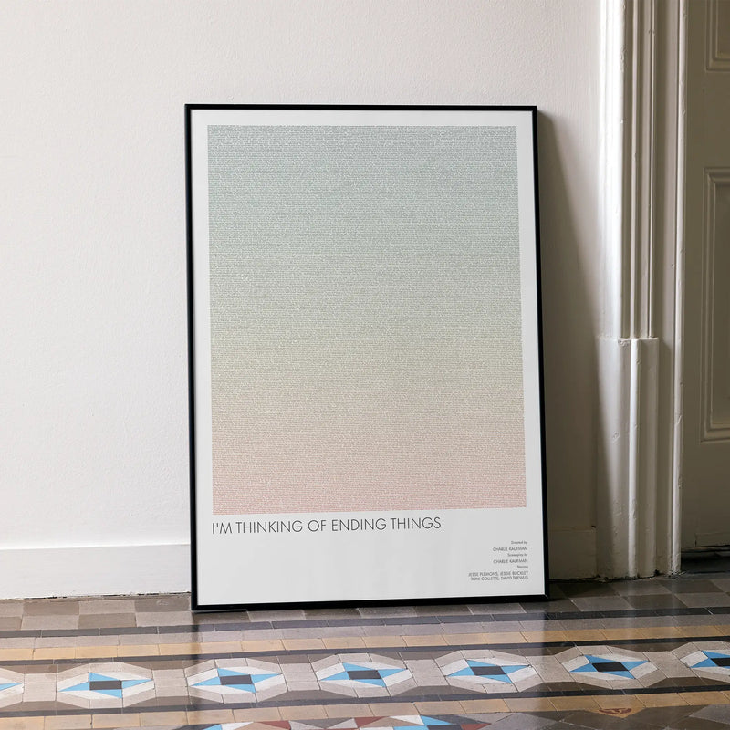 A framed I'm Thinking of Ending Things movie script poster leaning against a wall in a minimalist interior.