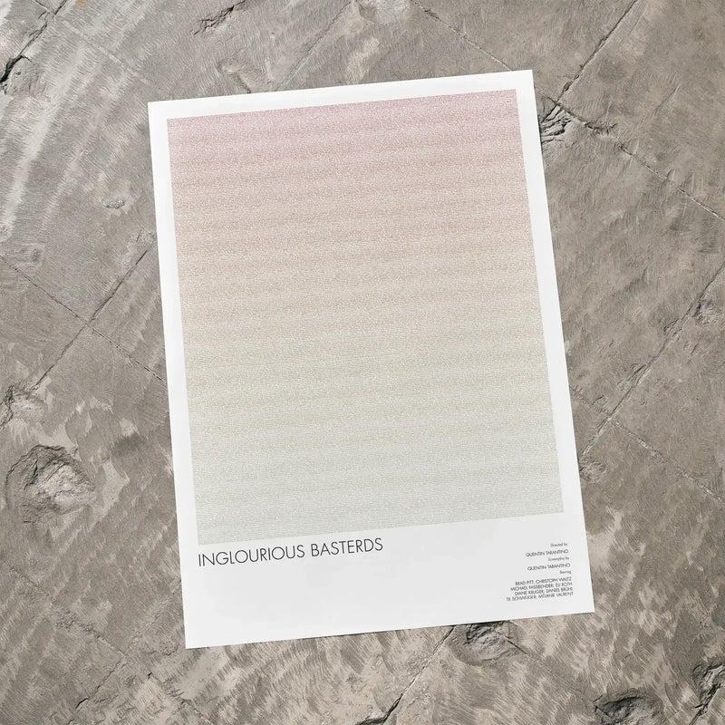 A Inglourious Basterds movie script poster laid flat on a textured floor surface.