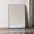 A framed Inglourious Basterds movie script poster leaning against a wall in a minimalist interior.