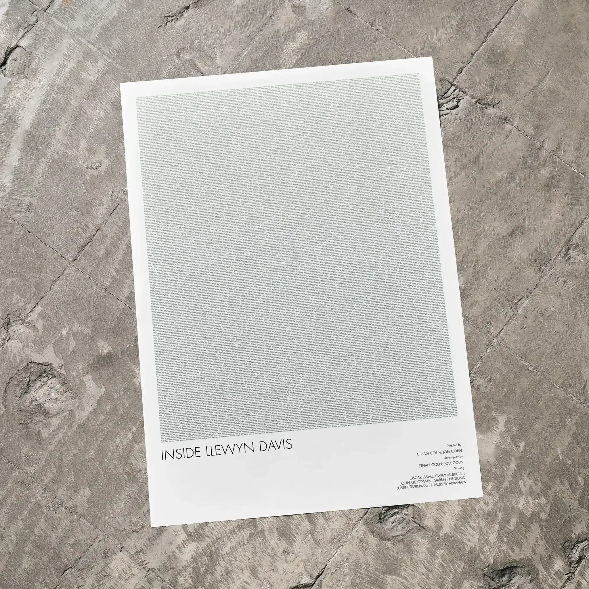 A Inside Llewyn Davis movie script poster laid flat on a textured floor surface.