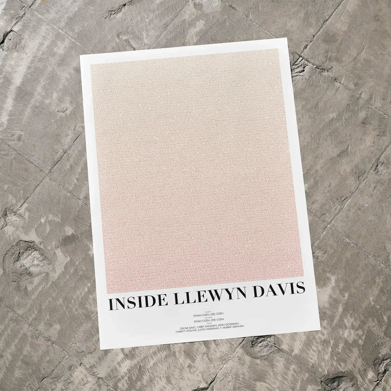A Inside Llewyn Davis movie script poster laid flat on a textured floor surface.