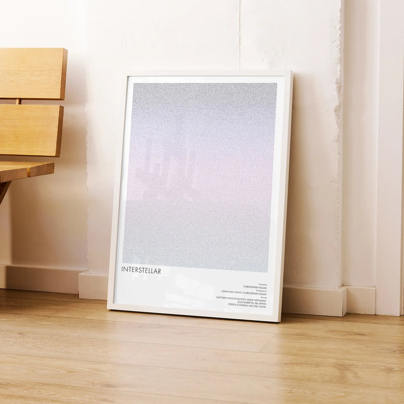 A framed Interstellar movie script poster leaning against a wall in a modern interior.