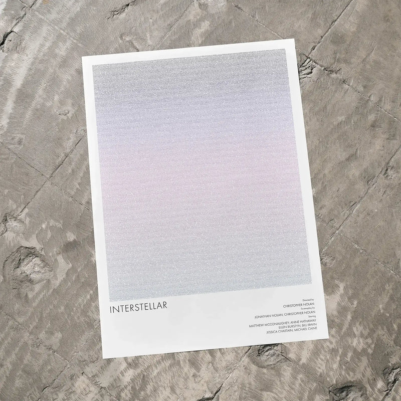 A Interstellar movie script poster laid flat on a textured floor surface.
