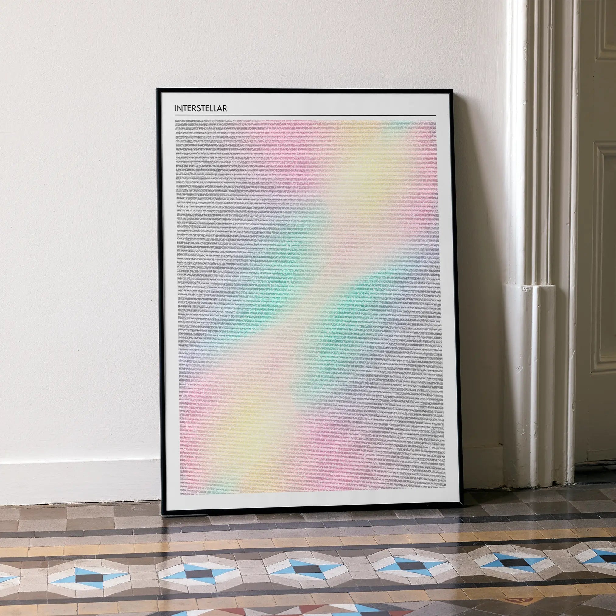 Framed Interstellar poster with a colorful design on a wall in a room with a patterned floor.