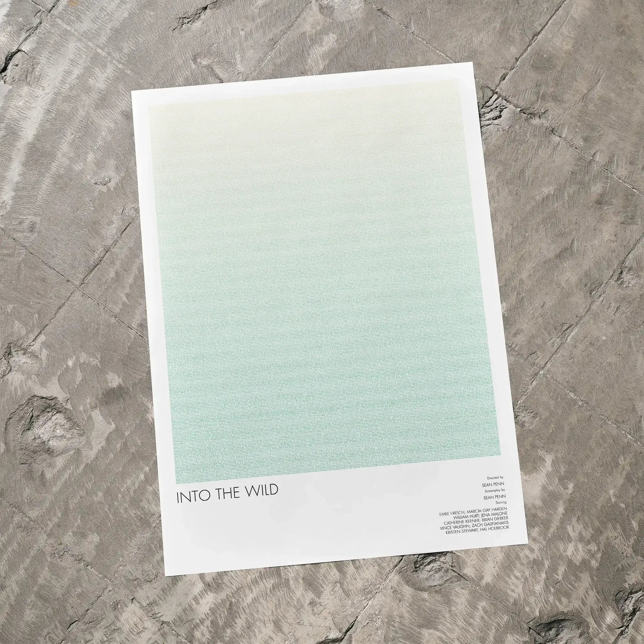 A Into the Wild movie script poster laid flat on a textured floor surface.