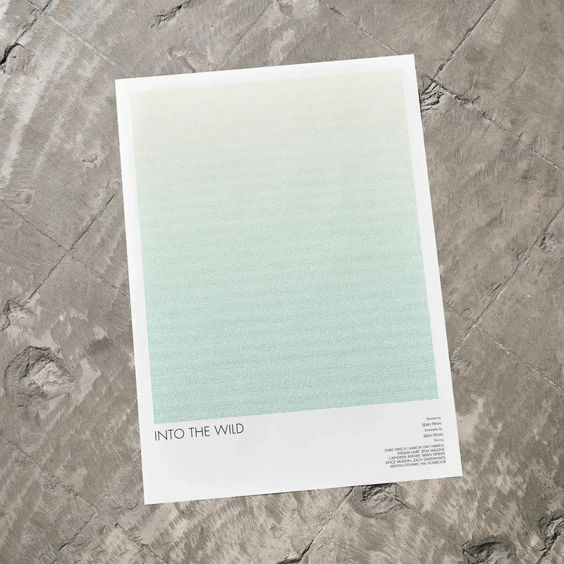 A Into the Wild movie script poster laid flat on a textured floor surface.