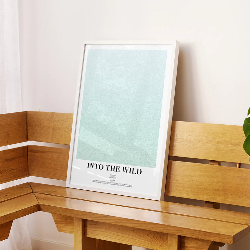 A framed Into the Wild movie script poster displayed on a sideboard in a contemporary space.