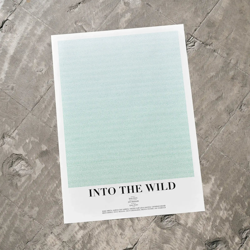 A Into the Wild movie script poster laid flat on a textured floor surface.