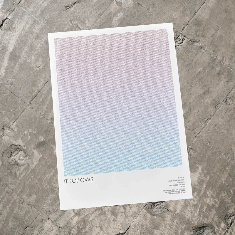 A It Follows movie script poster laid flat on a textured floor surface.