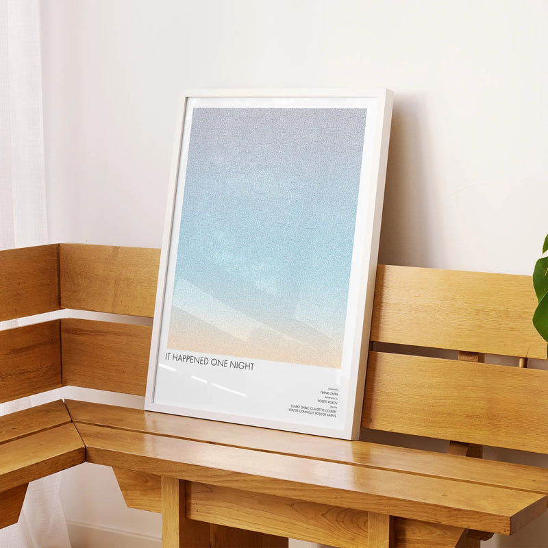 A framed It Happened One Night movie script poster displayed on a sideboard in a contemporary space.