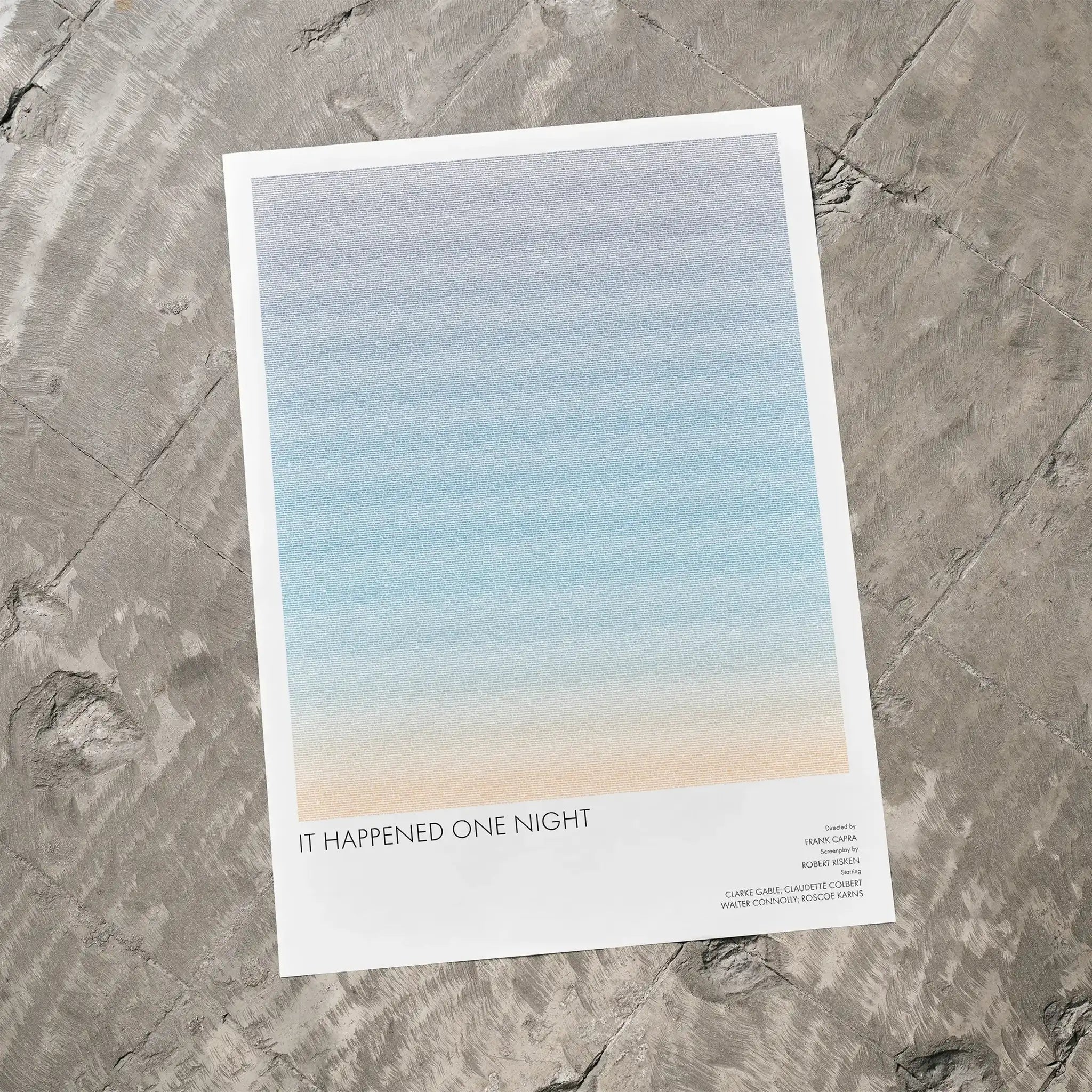 A It Happened One Night movie script poster laid flat on a textured floor surface.