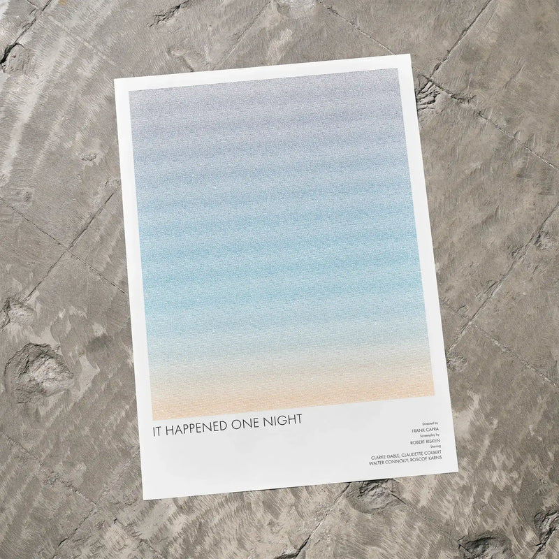 A It Happened One Night movie script poster laid flat on a textured floor surface.